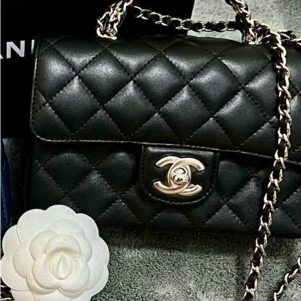 Chanel Black Lambskin Mini w/light Gold Chain/ Mint condition